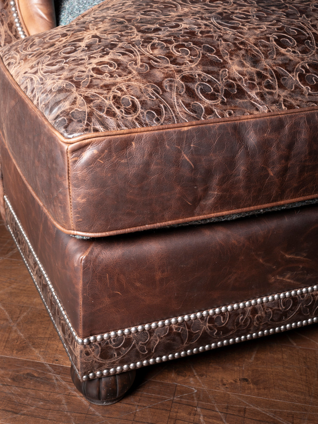 Turquoise Leather & Fabric Chaise Lounge with embossed leather cushion and nailhead trim detail in a close-up view.