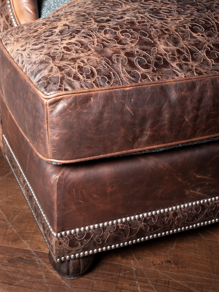 Turquoise Leather & Fabric Chaise Lounge with embossed leather cushion and nailhead trim detail in a close-up view.
