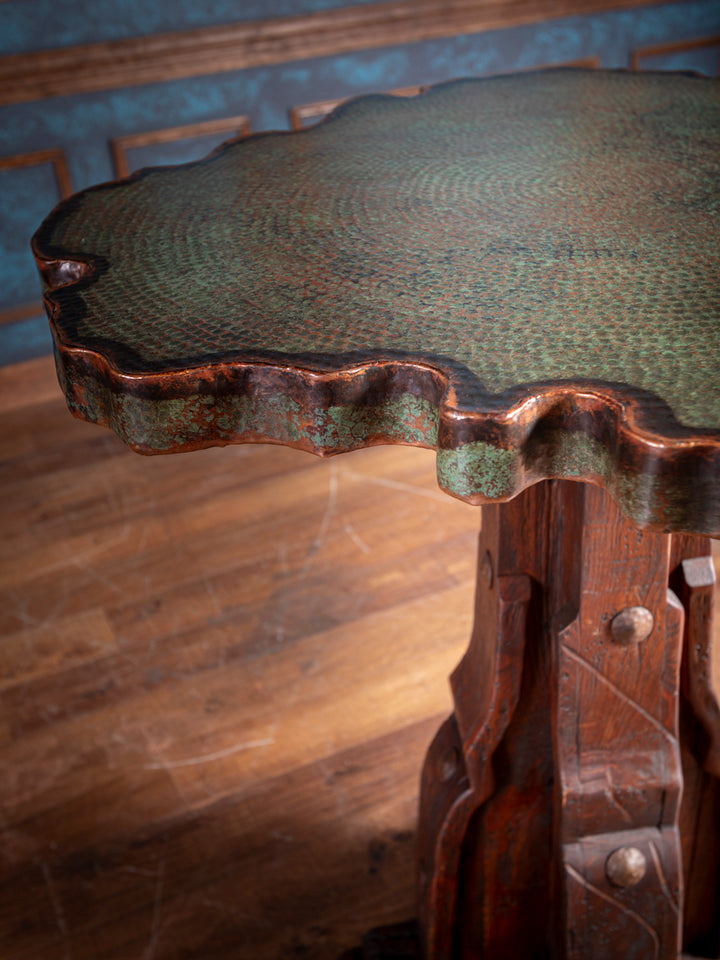 Close-up of hand-hammered verde copper tabletop with natural patina and live edge finish.