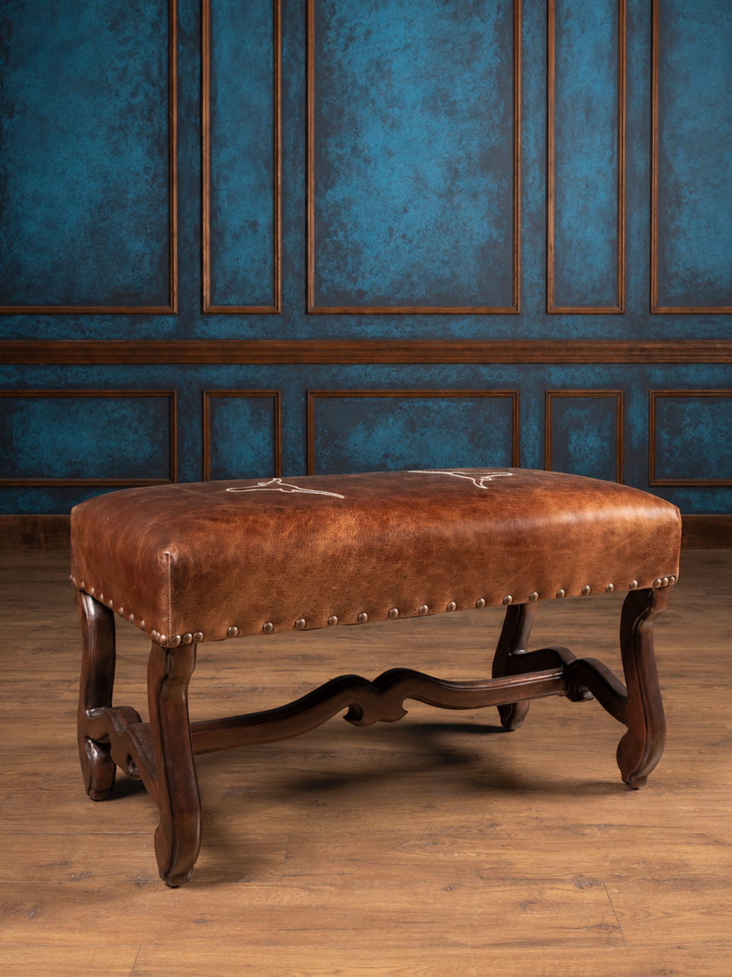 Front-facing view of the Vaquero Longhorn Leather Bench showcasing the hand-carved legs with brown leather seat cushions. 