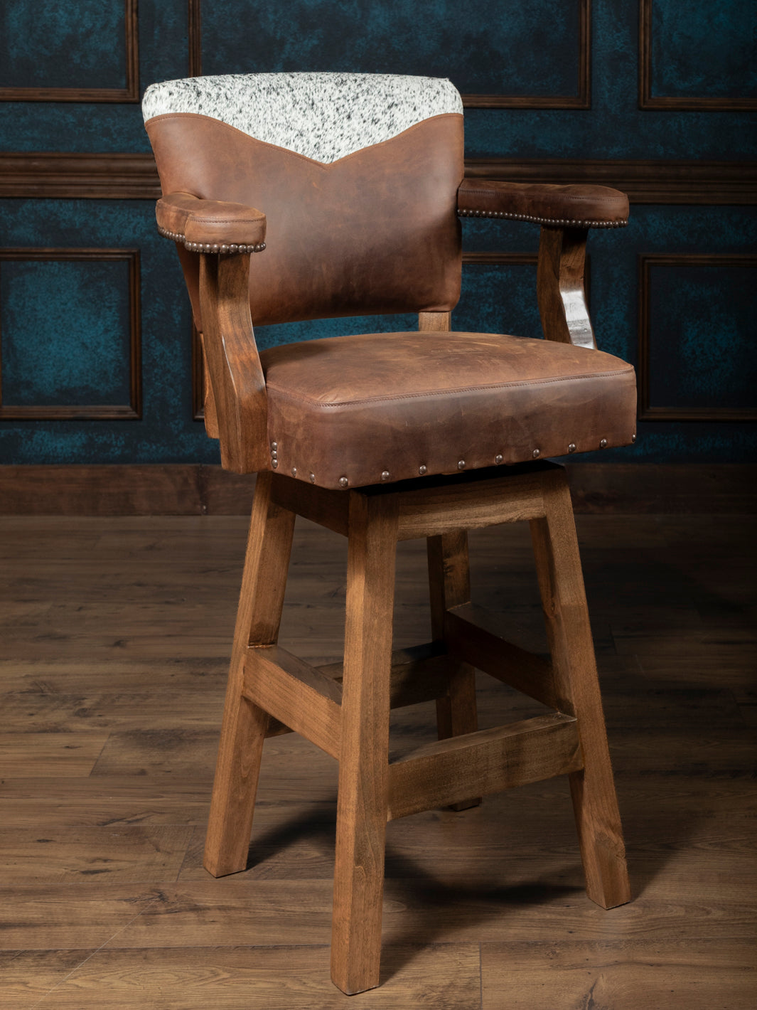 Western Heritage Leather Barstool with distressed brown leather and speckled cowhide accents in a western styled room.