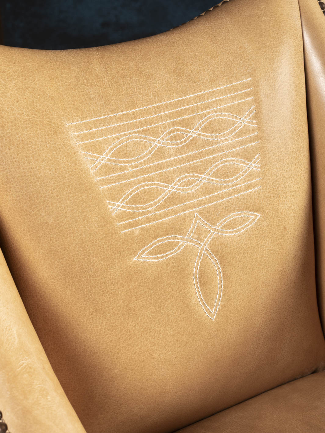 Detailed view of the Ridgecut chair's signature Western boot stitch embroidery on premium full-grain buffalo leather.