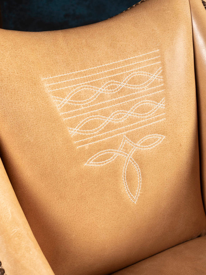 Detailed view of the Ridgecut chair's signature Western boot stitch embroidery on premium full-grain buffalo leather.