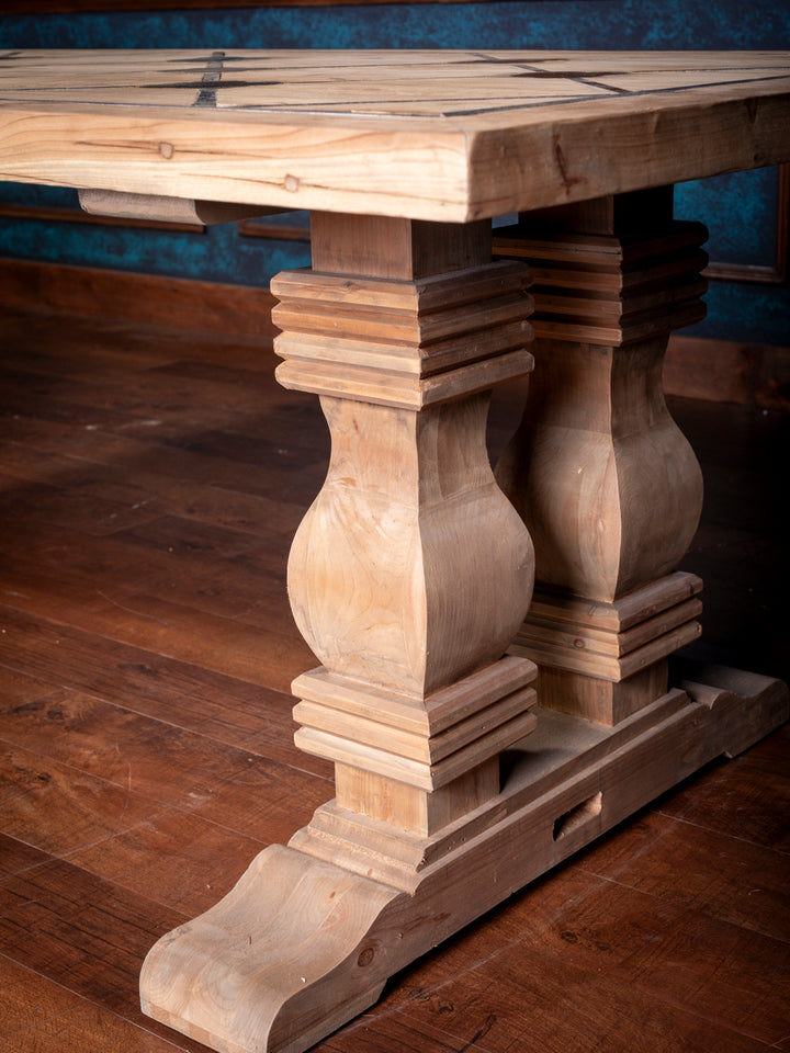 Wooden table with decorative legs on a wooden floor