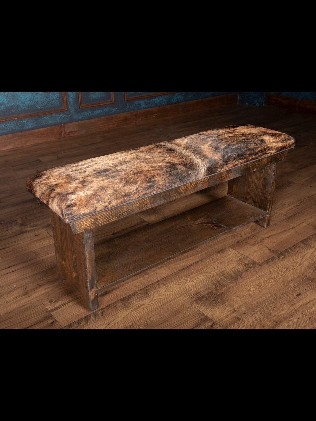 Wooden bench with a textured cushion against a wooden wall.