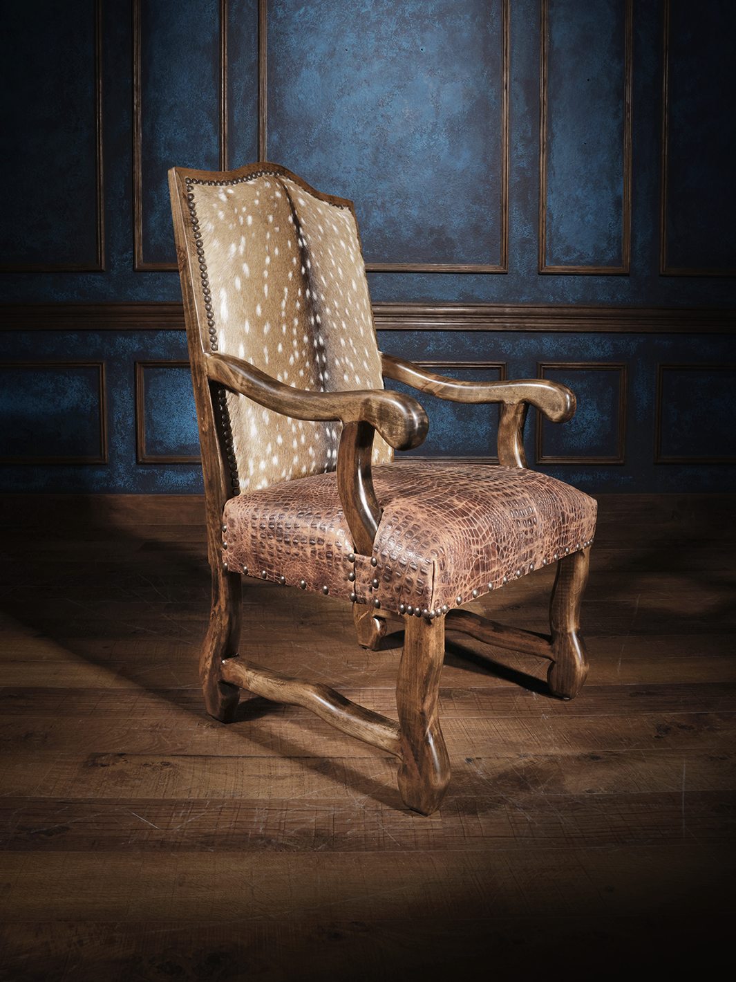 Armchair combining axis hair-on hide, crocodile-embossed leather, carved wood and nailhead trim