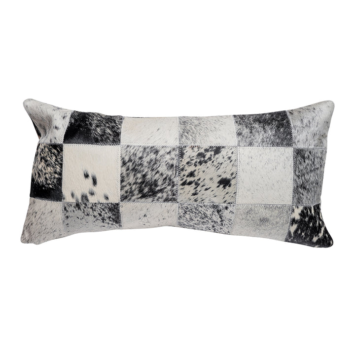 Lumbar pillow featuring a patchwork design in black, white, and gray hair on hide with a salt-and-pepper speckled pattern across the squares