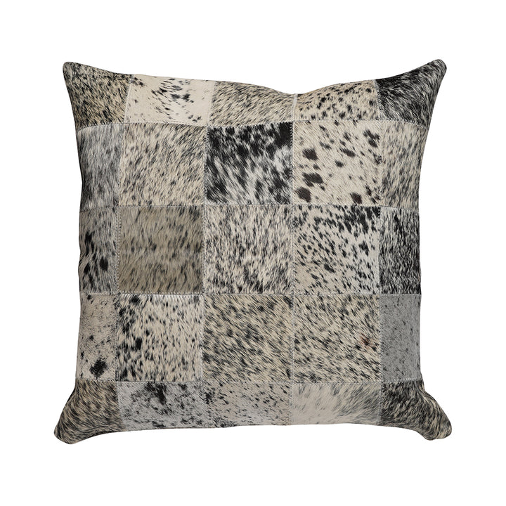 Square pillow featuring a patchwork design in black, white, and gray hair on hide with a salt-and-pepper speckled pattern across the squares.