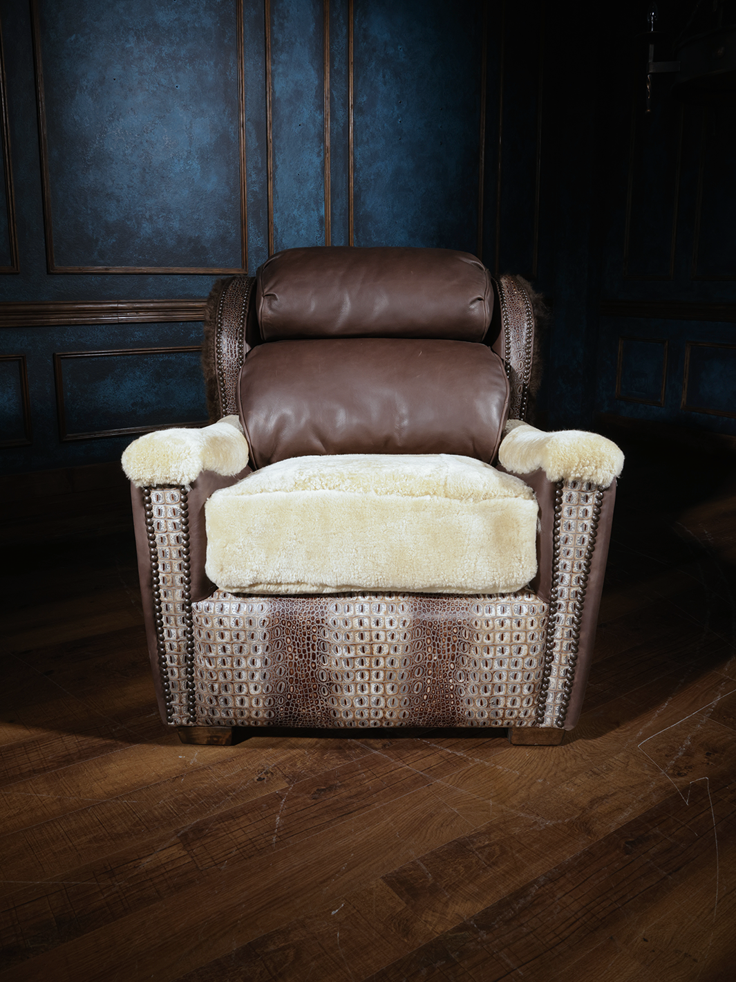 A luxurious accent chair featuring soft shearling seat and armrest covers, rich brown leather upholstery, and detailed crocodile-embossed leather accents on the sides and front.