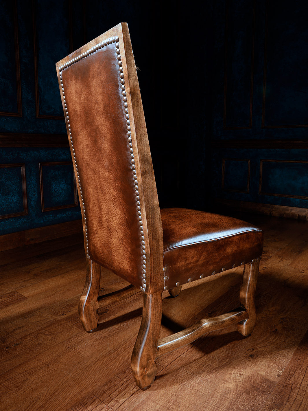 rear view of axis deer hide side chair with burnished leather seat