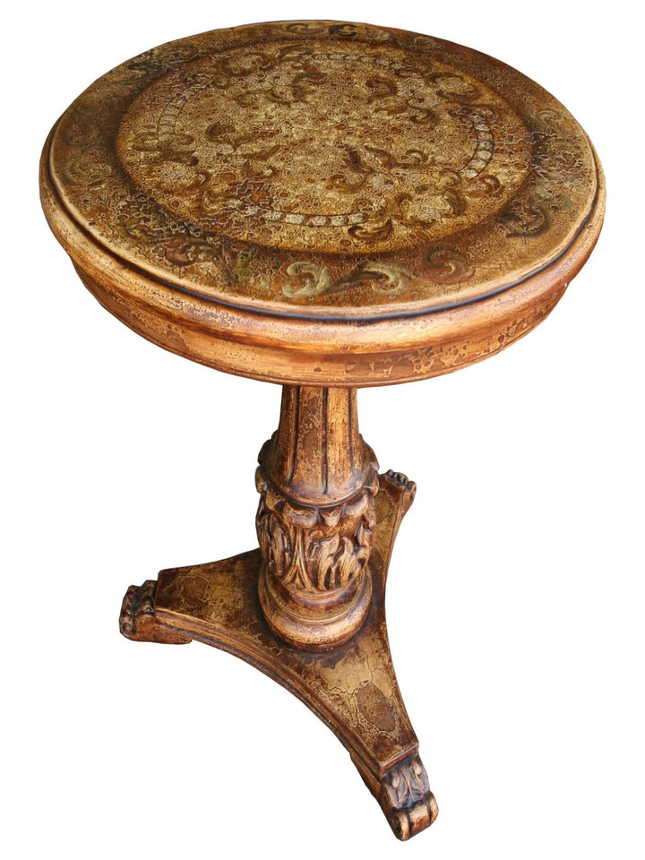 A round, wooden table with a floral pattern on the tabletop and ornate legs.