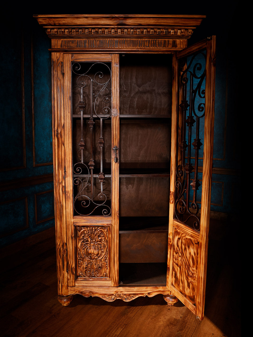 front view of brown wooden armoire with iron