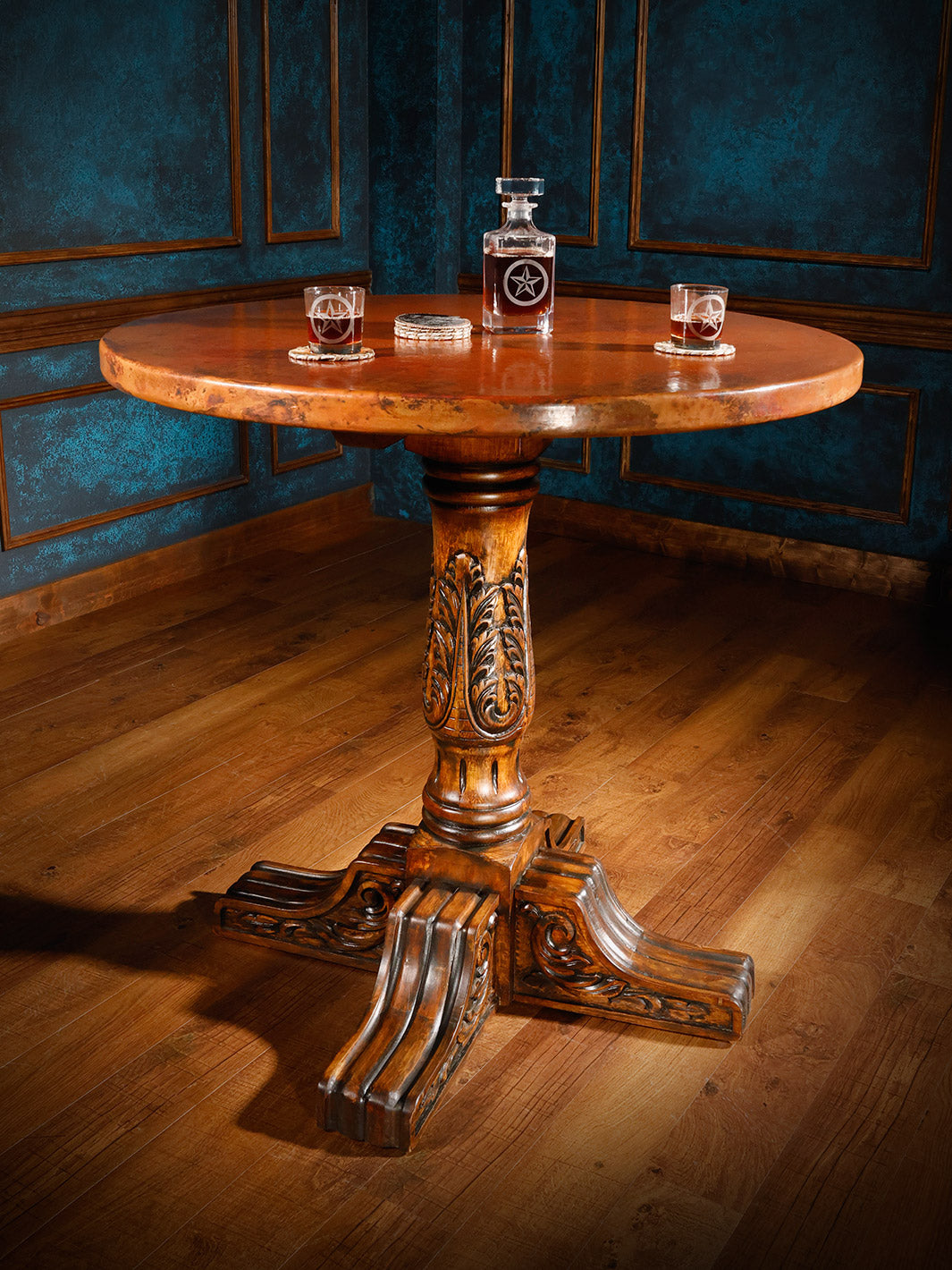 Copper top pub table with a round patina copper top and hand-carved base styled in a Western bar space.