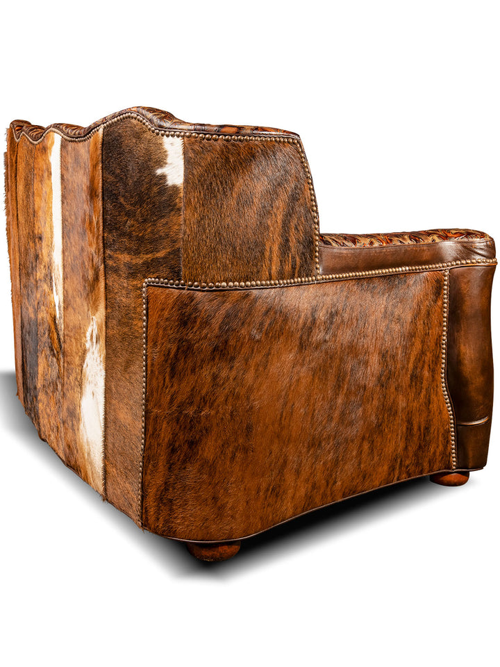 back side view of luxurious brown leather/cowhide tufted sofa
