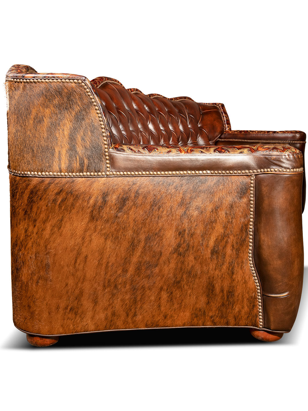 side view of luxurious brown leather/cowhide tufted sofa