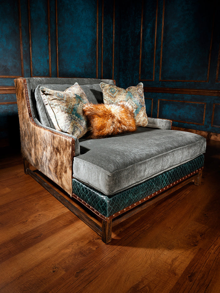 leather, hide, and fabric chaise lounge with beautiful decorative pillows