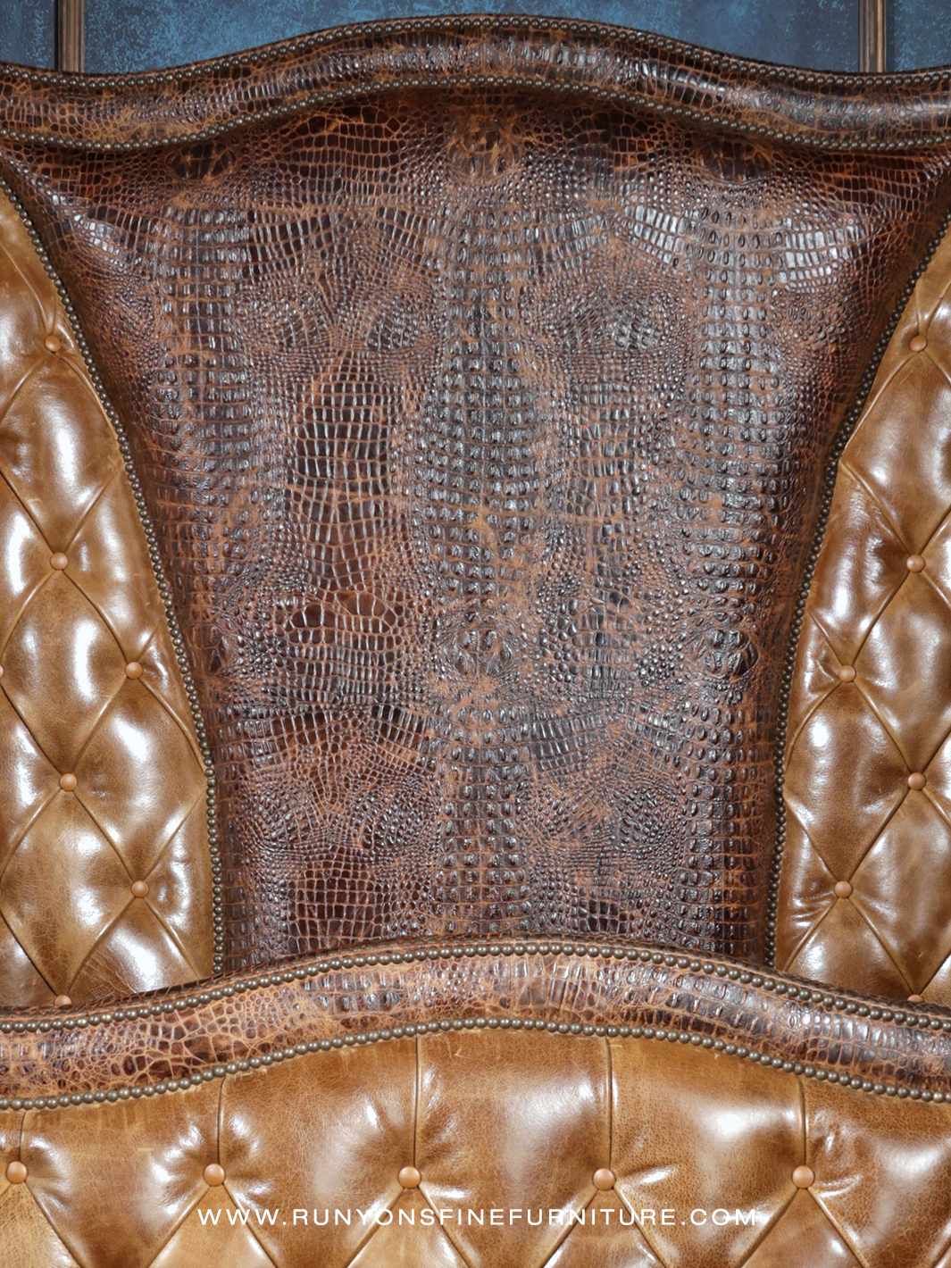 Crocodile Dundee Leather Tufted Bed in light brown leather with embossed leather accents, shown in a close-up view.