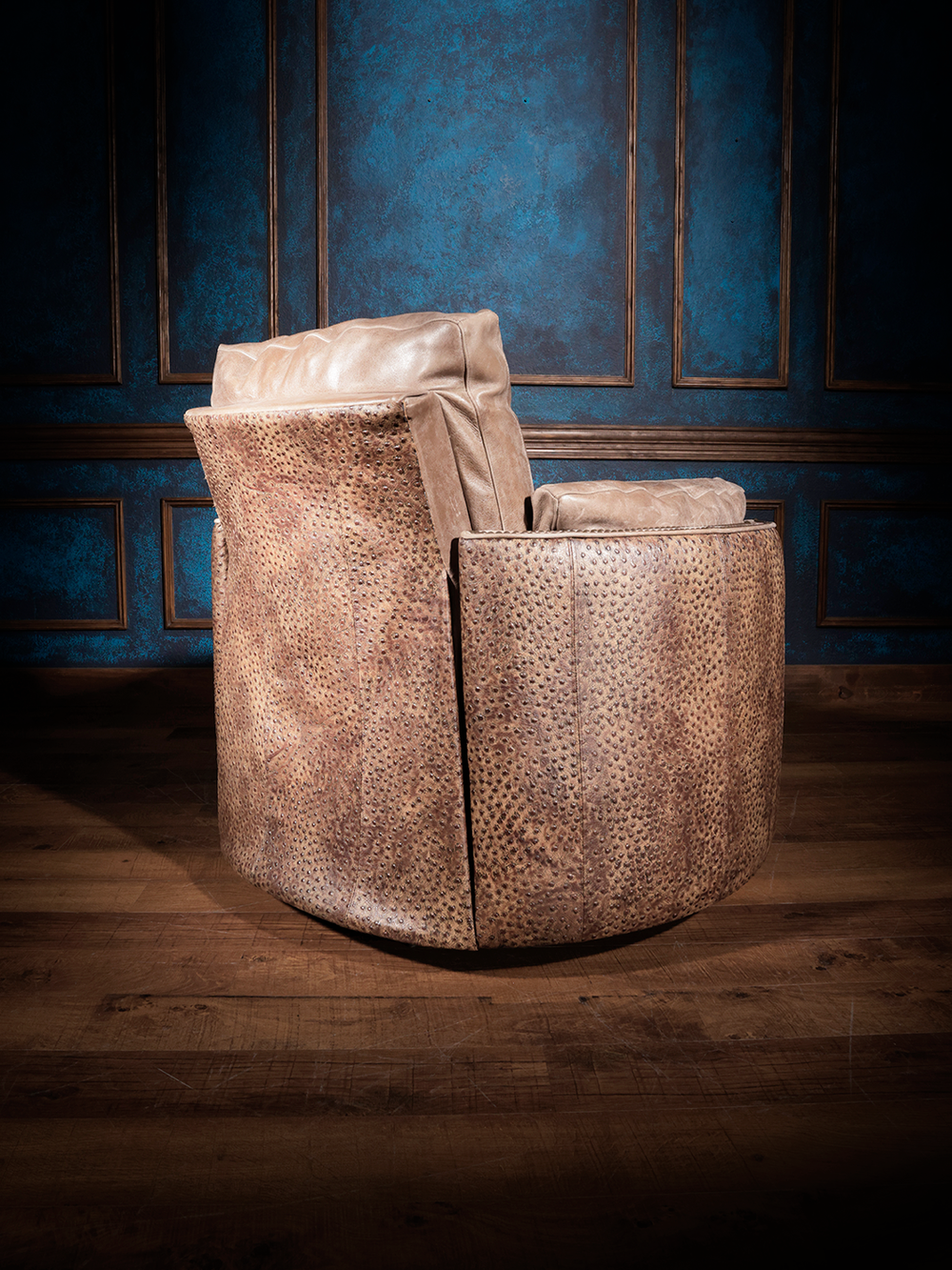 Ostrich Leather Snug Swivel Recliner in tan leather with embossed ostrich leather accents in a Western living room.
