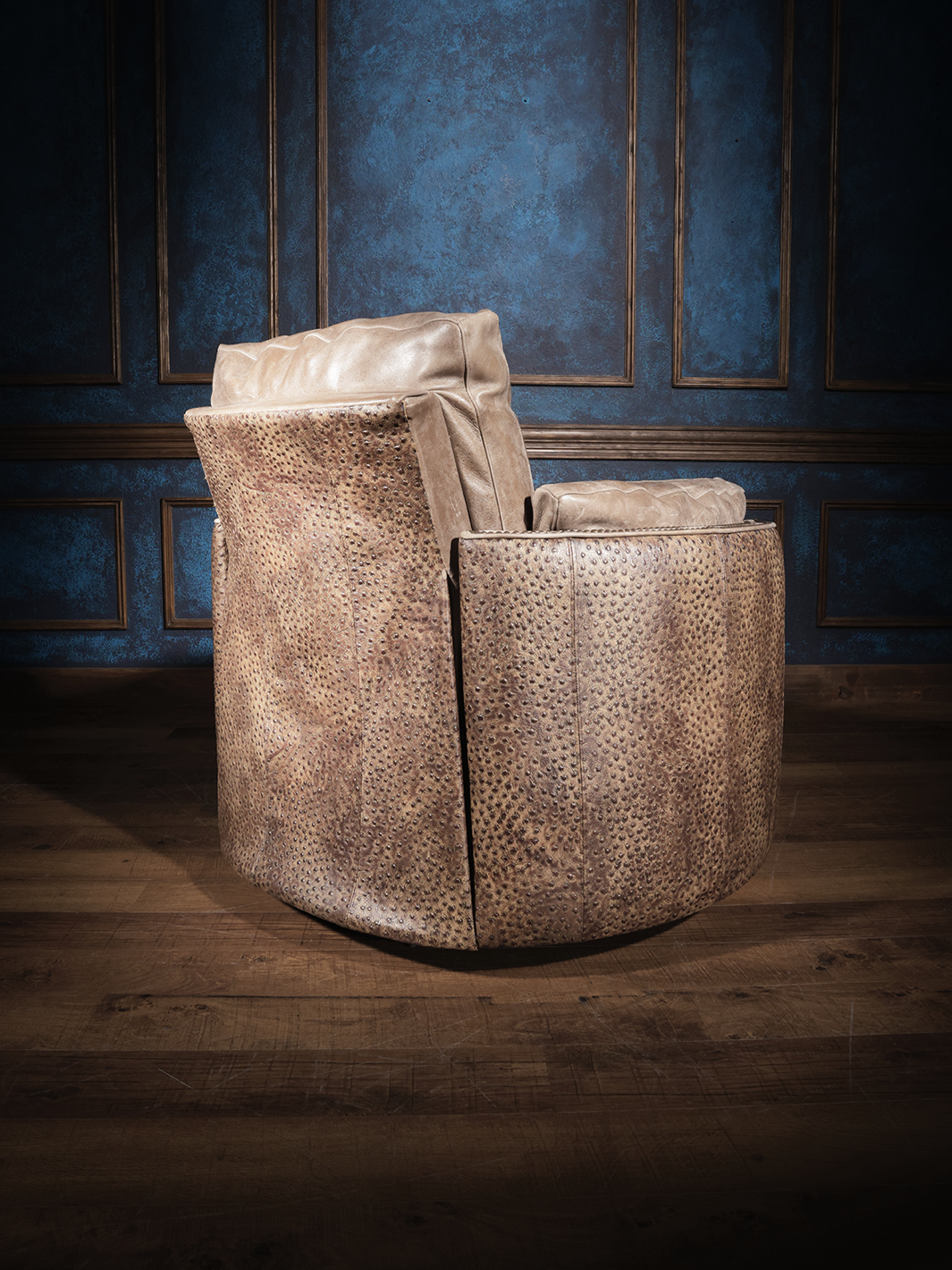 Ostrich Leather Snug Swivel Recliner in tan leather with embossed ostrich leather accents in a Western living room.