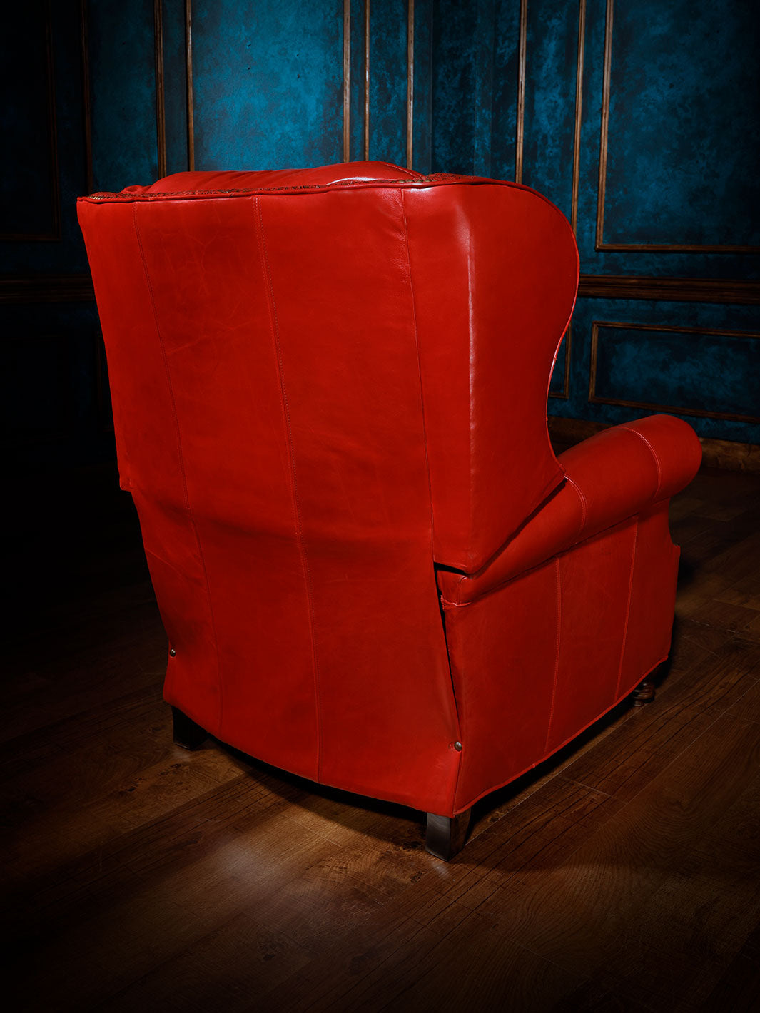 Red Rider Western Leather Recliner in distressed Ruby Red leather on outside back and arms in a spacious rustic lodge room.