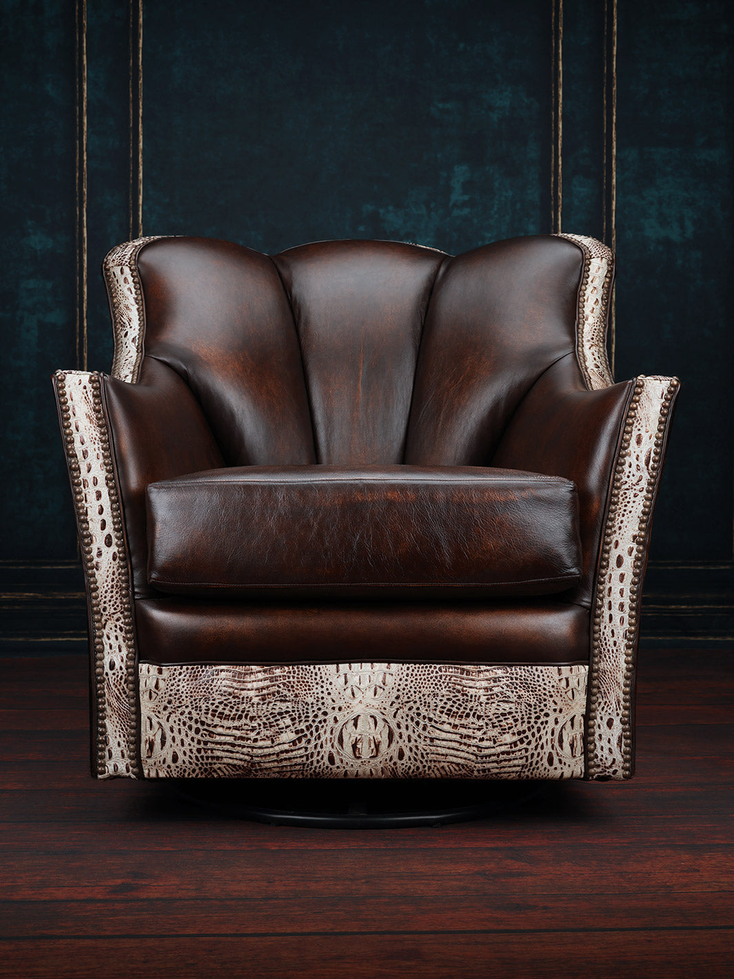 Tahoe Leather & Cowhide Swivel Chair in burnished brown leather with embossed crocodile leather trim detailing in a moody room space.