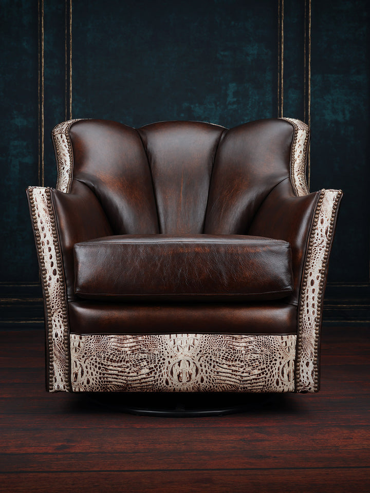 Tahoe Leather & Cowhide Swivel Chair in burnished brown leather with embossed crocodile leather trim detailing in a moody room space.