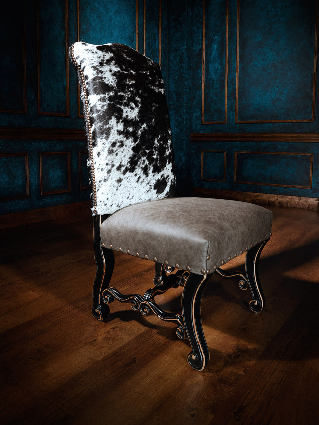 Texas Outlaw Cowhide Western Dining Chair with top grain leather seat and speckled cowhide back in western dining space.