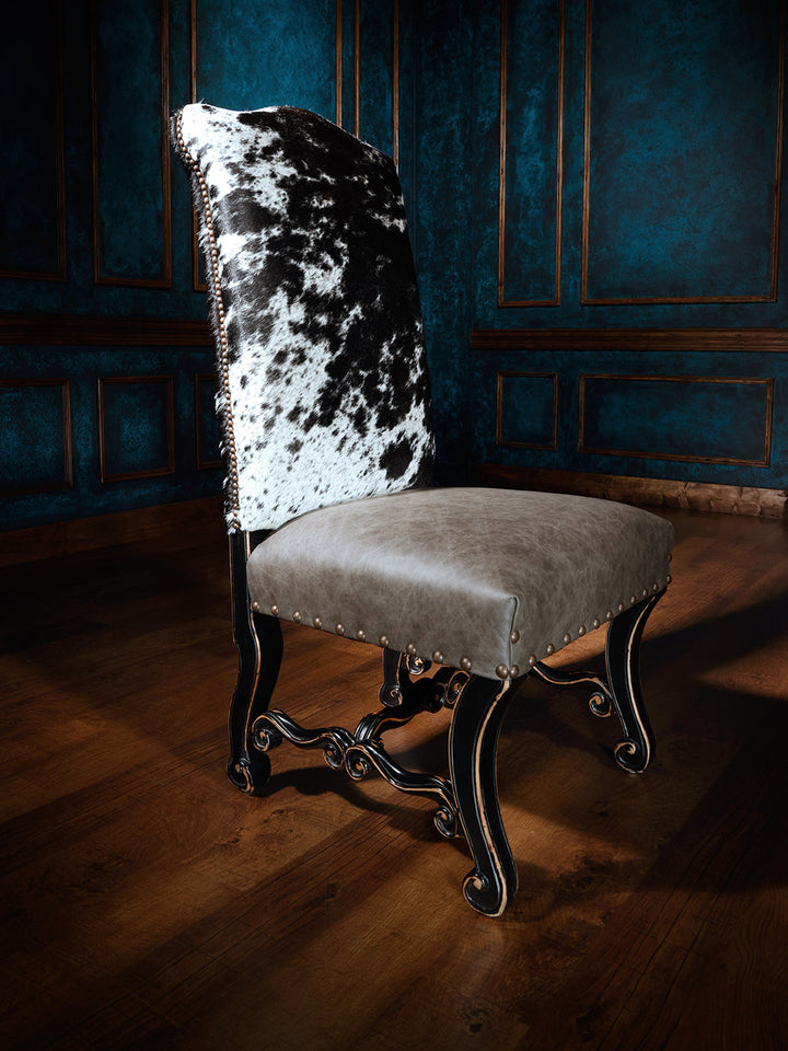 Texas Outlaw Cowhide Western Dining Chair with top grain leather seat and speckled cowhide back in western dining space.