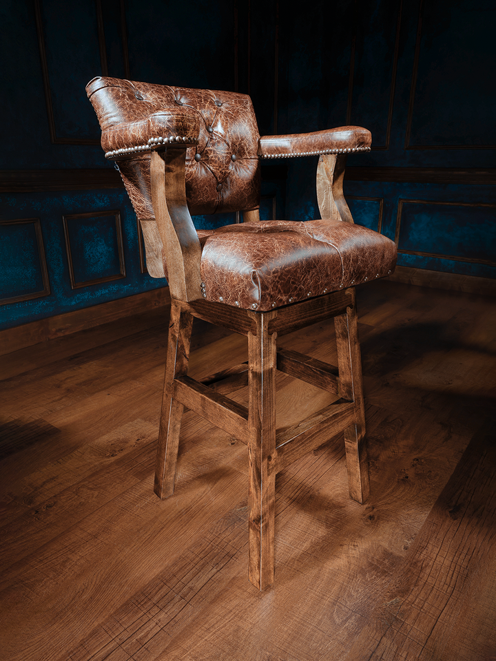 Texas Sunrise Chisum Western Bar Stool with top grain leather and tufted seat accents in a moody bar space.