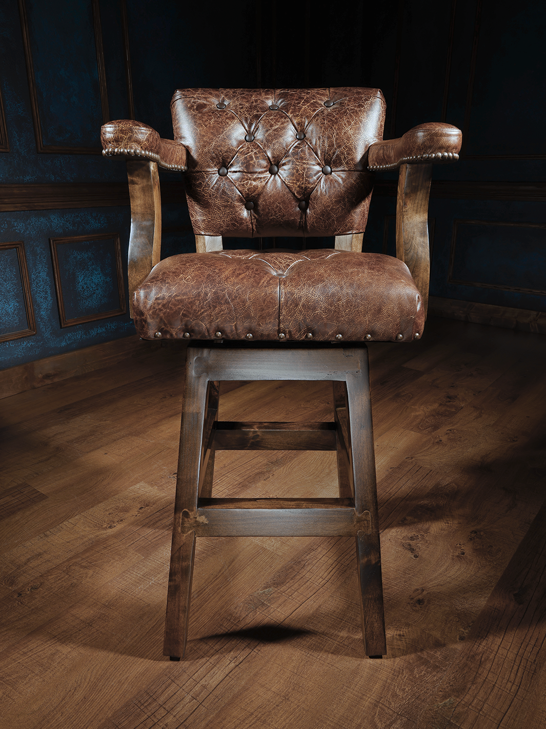 Texas Sunrise Chisum Western Bar Stool in top-grain leather with tufted seats and nailhead trim in a studio space.